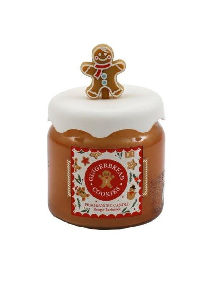 Jar of gingerbread cookie spread with a gingerbread man on top against a white background