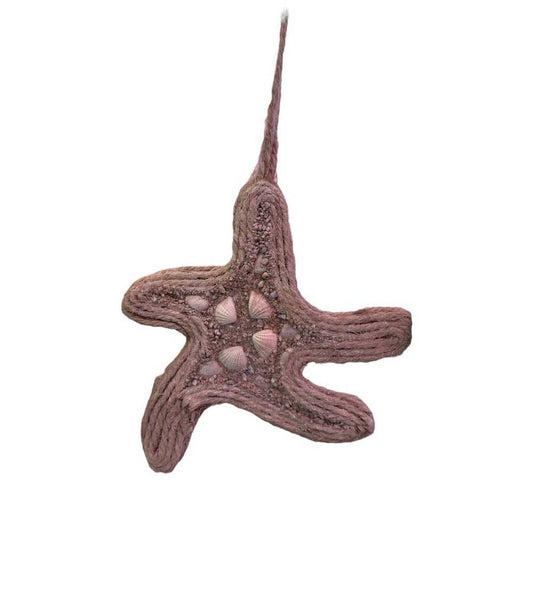 Decorative star with sand and seashells