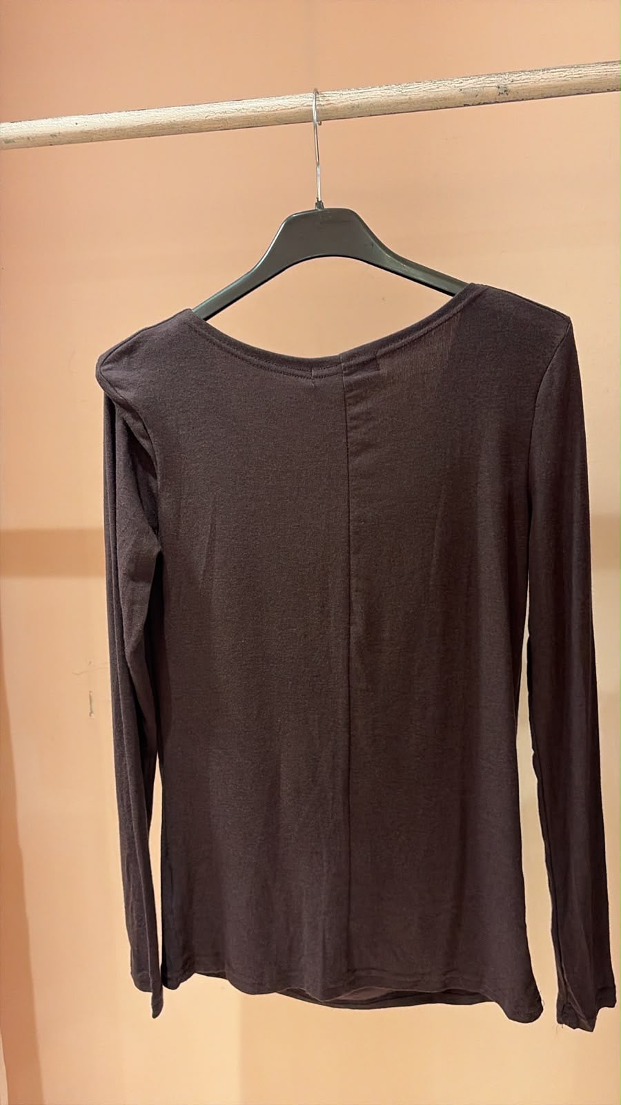Back of dark charcoal long-sleeve top showing a plain neckline and centre seam
