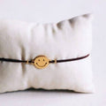 Elastic bracelet with smiley - brown