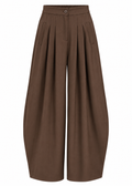 Model wearing brown high-waisted wide-leg trousers with front pleats and a full-length silhouette