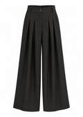Model wearing black high-waisted wide-leg trousers with front pleats and a fluid, floor-length silhouette