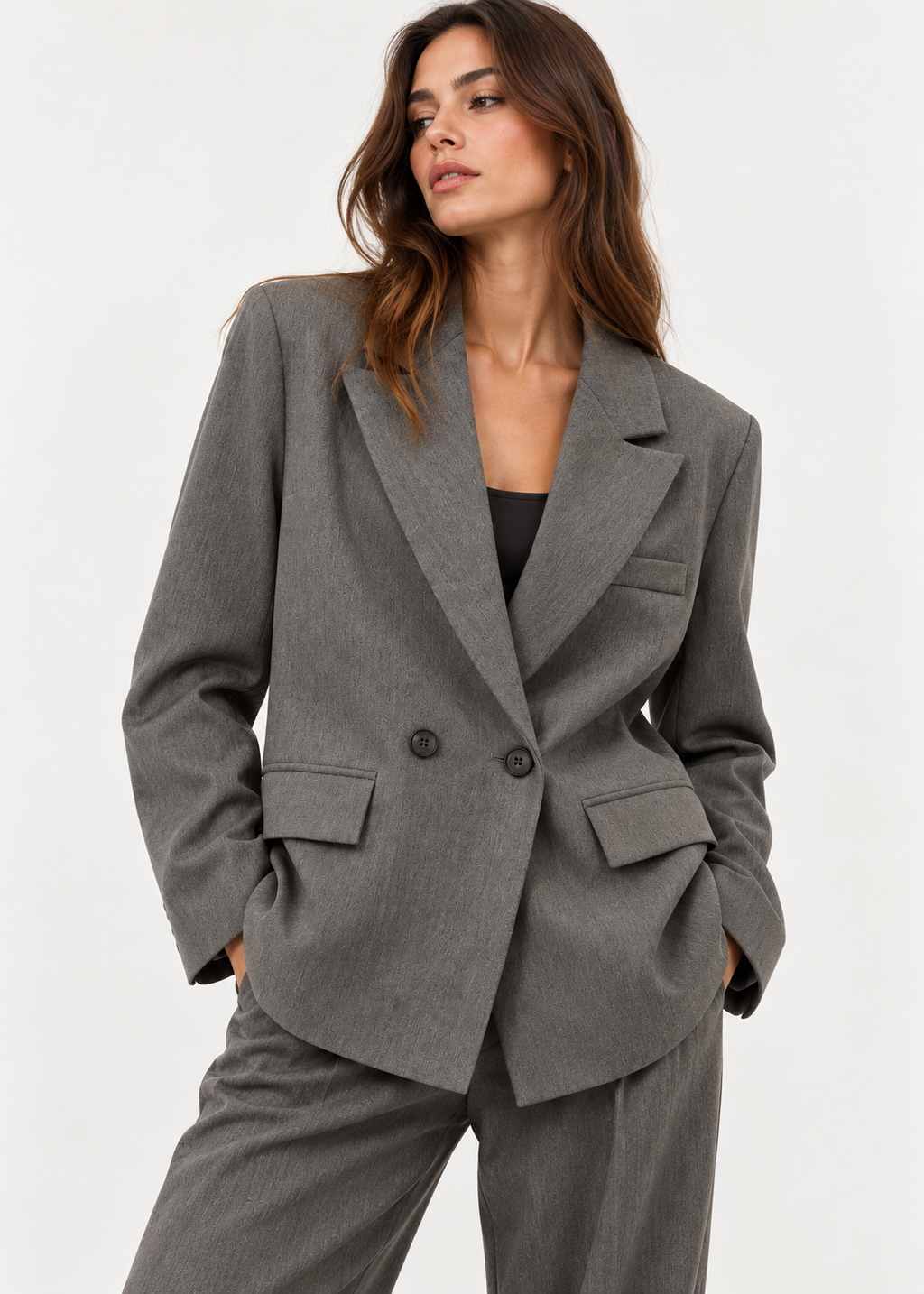 Grey double-breasted blazer styled on a model with grey trousers and a black top