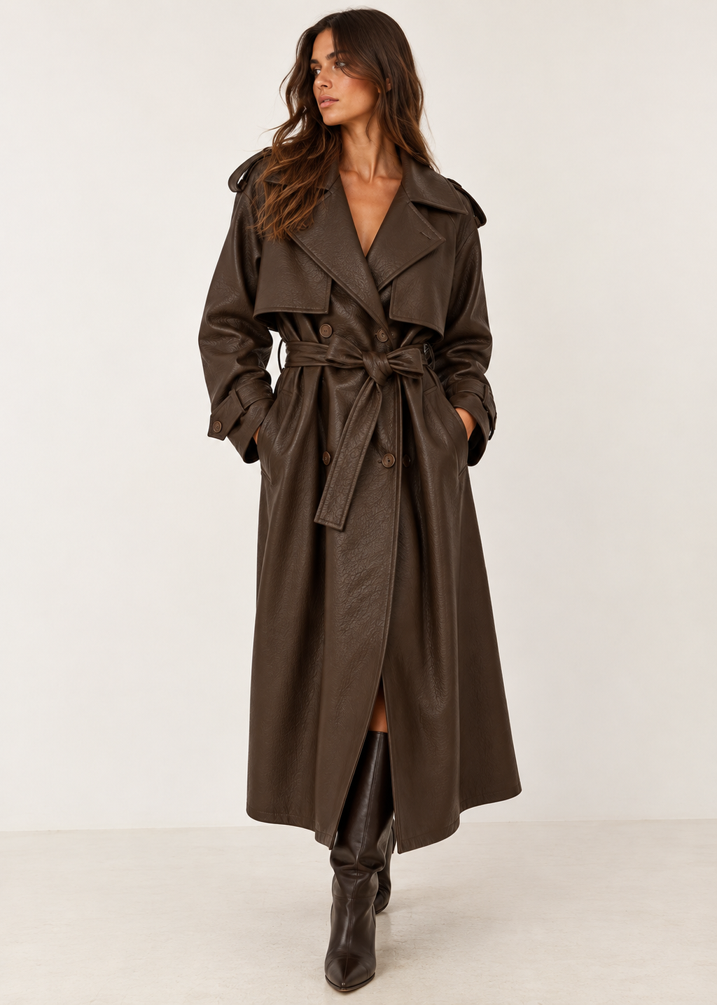 Chocolate brown belted trench coat styled on a model with tall boots