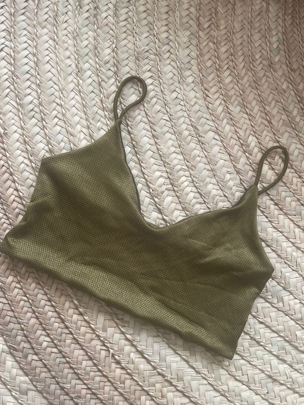 Green crop top on a textured surface