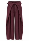 Front view of burgundy wide-leg trousers with draped wrap-style panels and tie-waist detail