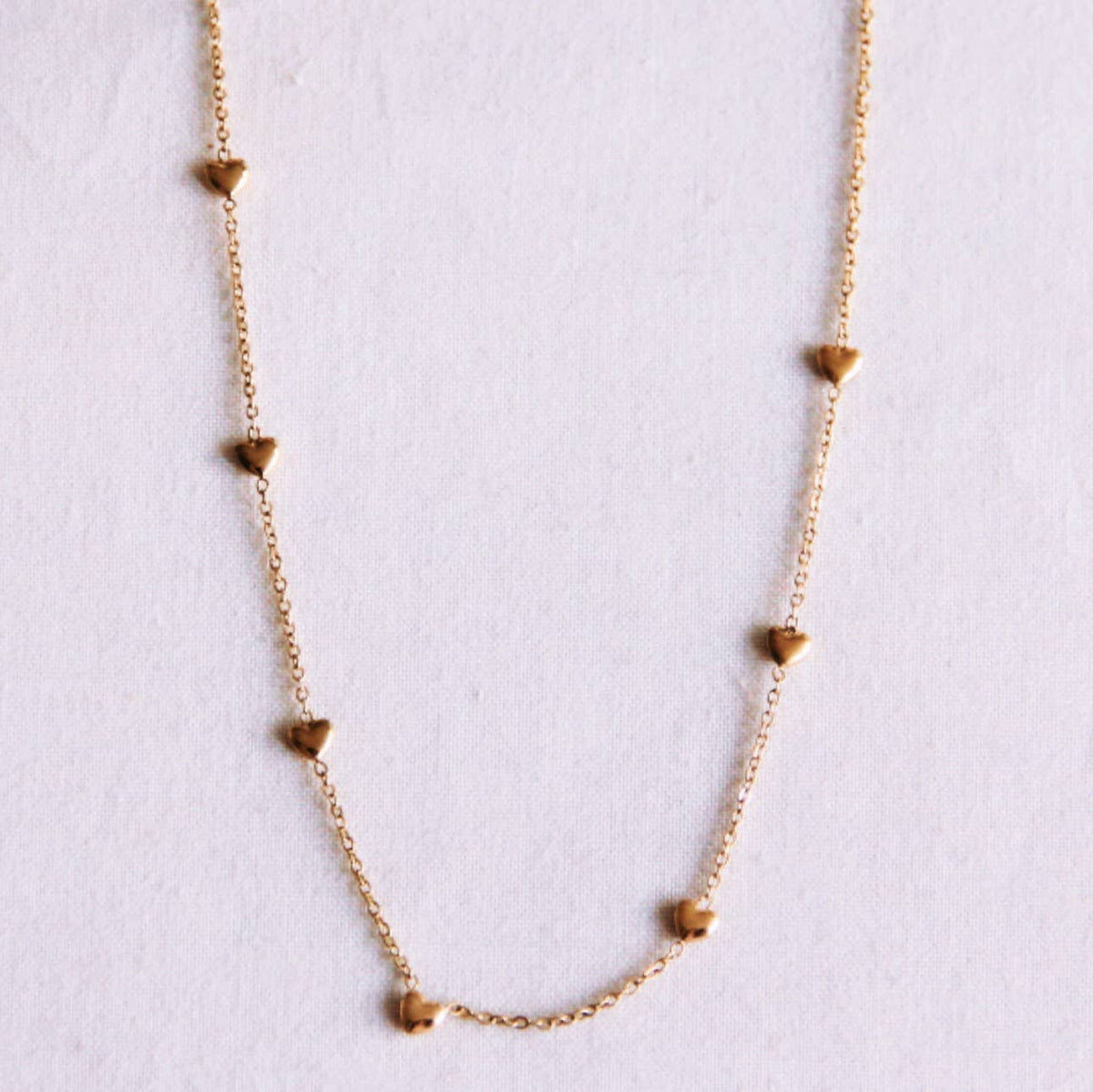 Delicate necklace with hearts - gold