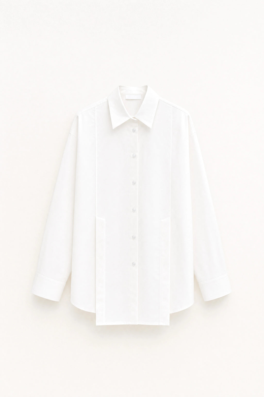 White fitted longline shirt with pointed collar and button front shown on a white background