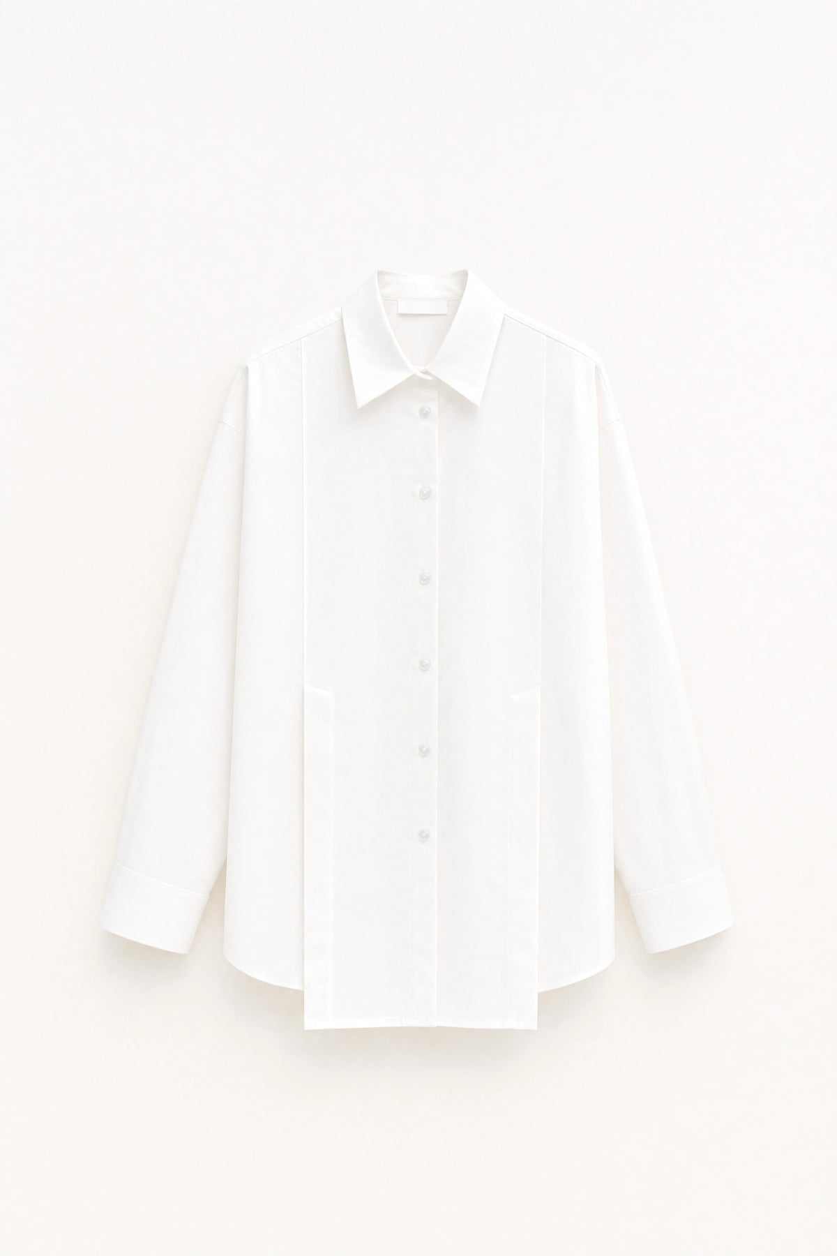 White fitted longline shirt with pointed collar and button front shown on a white background