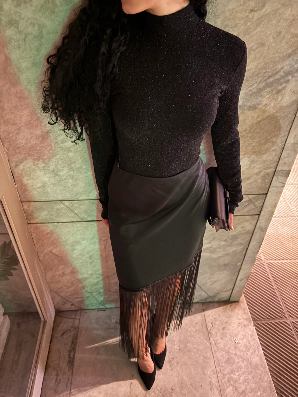 Front view of a black high-neck long-sleeve bodysuit with metallic flecks